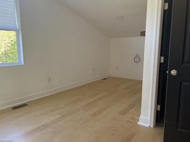 interior space featuring baseboards, visible vents, and light wood finished floors