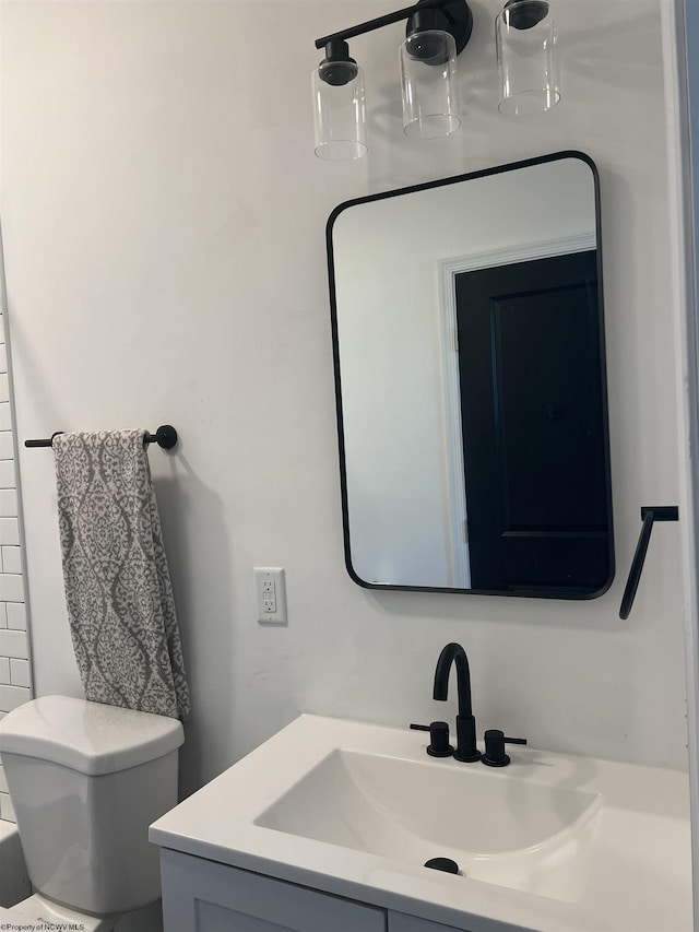 bathroom with toilet and vanity