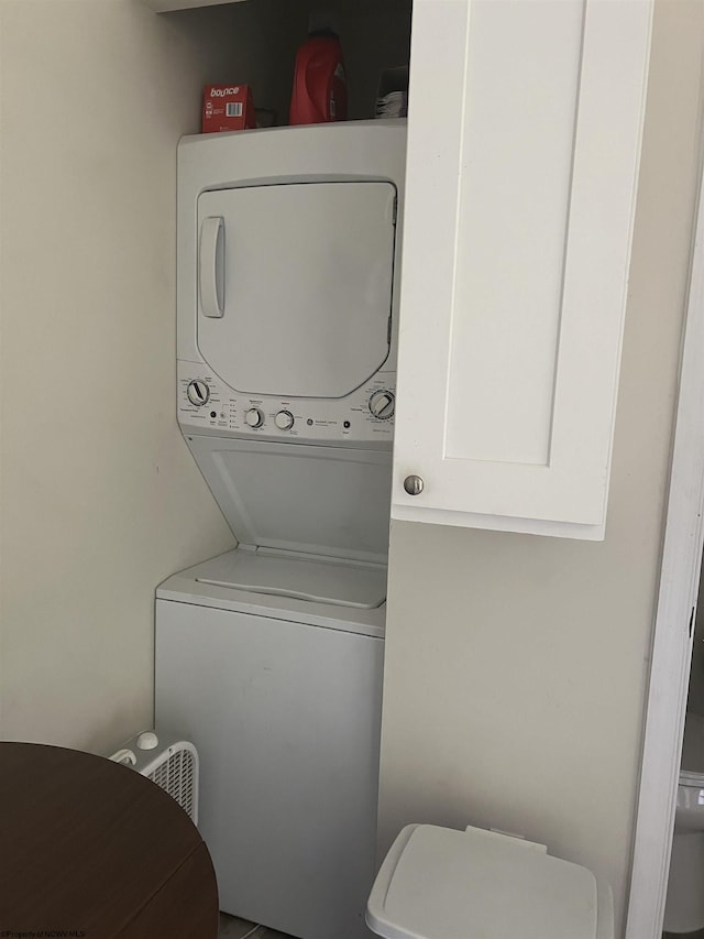 laundry room with stacked washer / dryer and laundry area