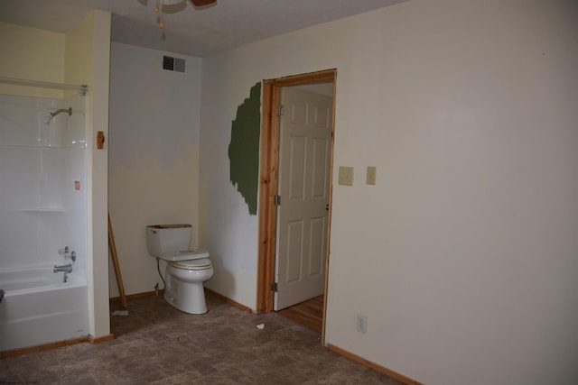 interior space featuring ceiling fan and dark tile flooring