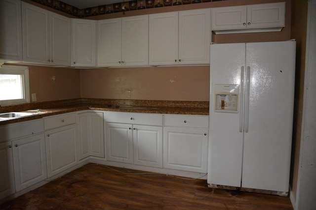 kitchen featuring white refrigerator with ice dispenser, white cabinetry, and dark hardwood / wood-style flooring