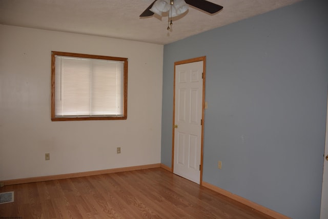 empty room featuring ceiling fan and light hardwood / wood-style floors