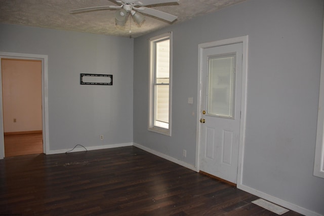 spare room featuring dark hardwood / wood-style flooring and ceiling fan