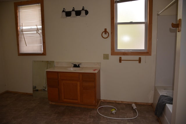 bathroom featuring vanity and a tub