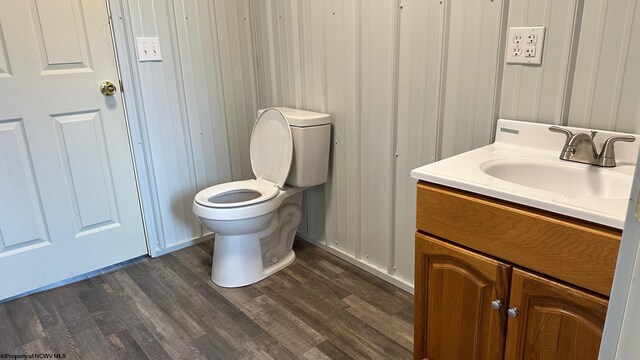 bathroom with vanity, wood-type flooring, and toilet