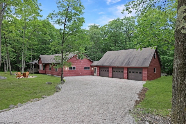 view of front of home with a garage and a front lawn