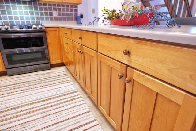 kitchen with tasteful backsplash and double oven range