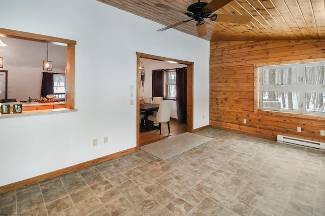 empty room featuring lofted ceiling, wood ceiling, a baseboard radiator, wooden walls, and ceiling fan