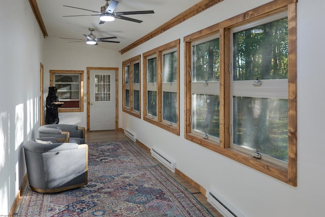 sunroom / solarium with lofted ceiling, a baseboard radiator, and ceiling fan