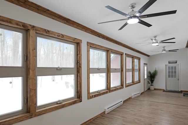 unfurnished sunroom featuring baseboard heating