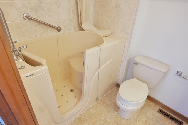 bathroom with toilet and a bath