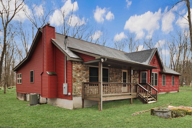 exterior space featuring cooling unit and a lawn