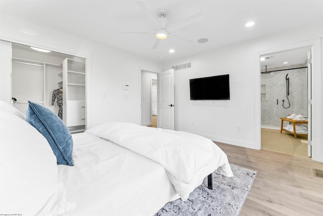 bedroom featuring ceiling fan, a closet, connected bathroom, and light hardwood / wood-style flooring