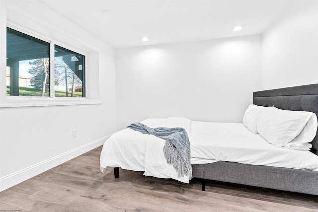 bedroom with hardwood / wood-style flooring