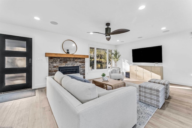 living room featuring ceiling fan and light wood-type flooring