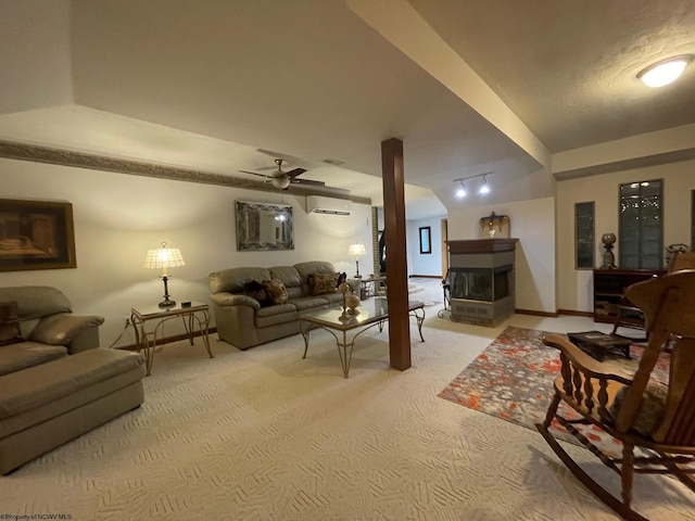 carpeted living room with a fireplace and ceiling fan