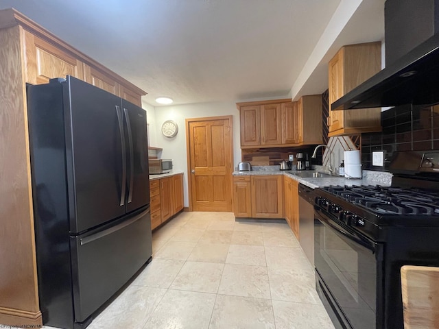 kitchen featuring light tile flooring, tasteful backsplash, wall chimney exhaust hood, black appliances, and sink