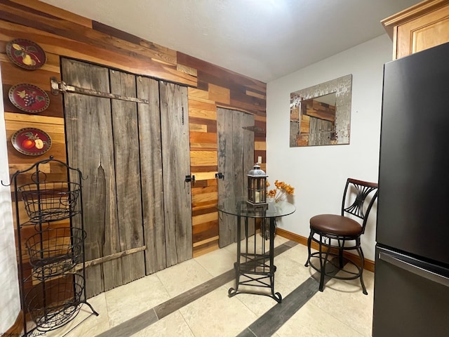 interior space featuring wooden walls and light tile floors