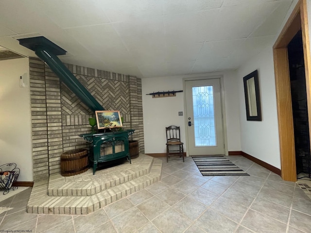 tiled foyer entrance featuring brick wall and a wood stove