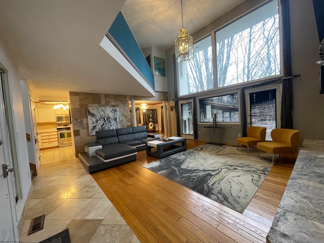 tiled living room featuring an inviting chandelier