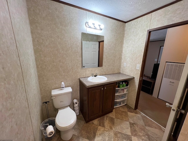 bathroom featuring toilet, oversized vanity, a textured ceiling, ornamental molding, and tile flooring