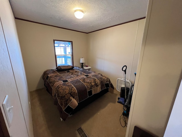 bedroom featuring a textured ceiling and carpet