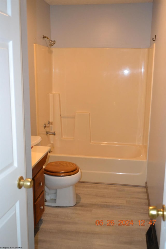 full bathroom featuring vanity, toilet, hardwood / wood-style floors, and shower / bathing tub combination