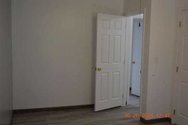 spare room with dark wood-type flooring