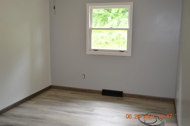 spare room with light hardwood / wood-style floors