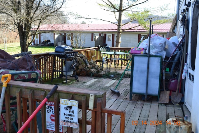 wooden terrace with area for grilling