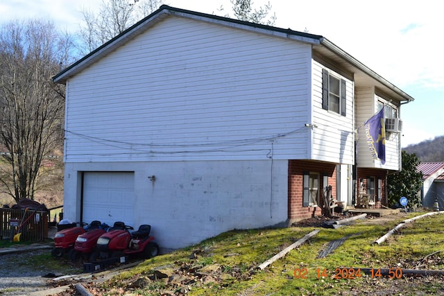 view of side of home featuring a garage