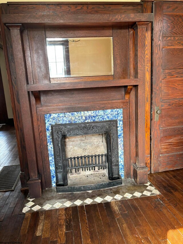 room details featuring a premium fireplace and hardwood / wood-style floors