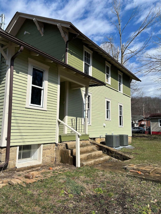 back of property featuring central air condition unit