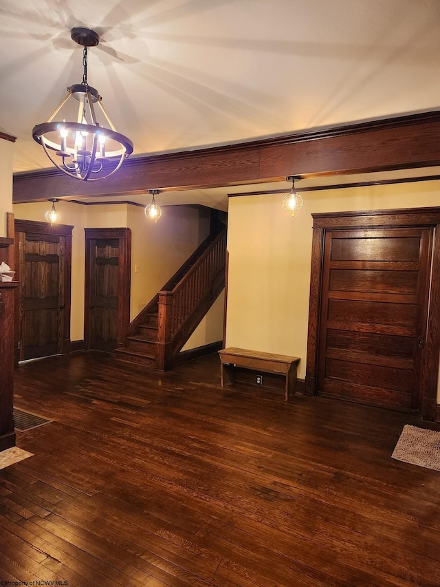 foyer featuring an inviting chandelier and dark hardwood / wood-style floors