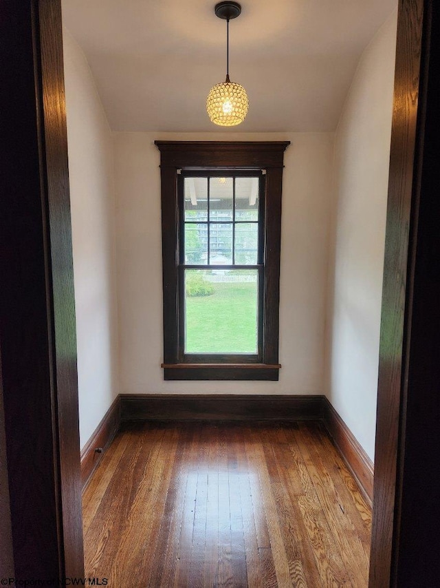 spare room with vaulted ceiling and dark hardwood / wood-style flooring