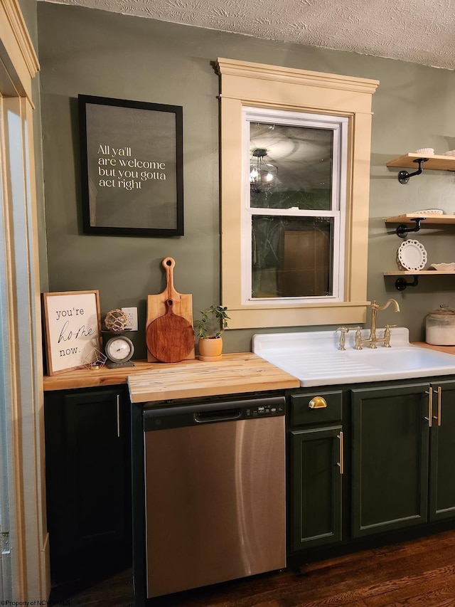 bar featuring dishwasher, sink, dark wood-type flooring, and a textured ceiling