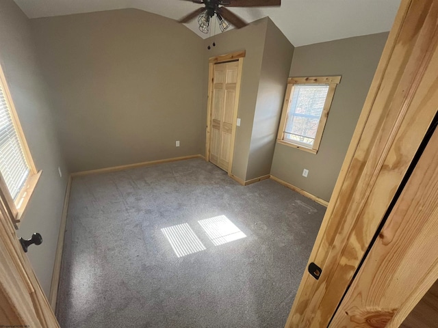 unfurnished bedroom featuring carpet, ceiling fan, and vaulted ceiling