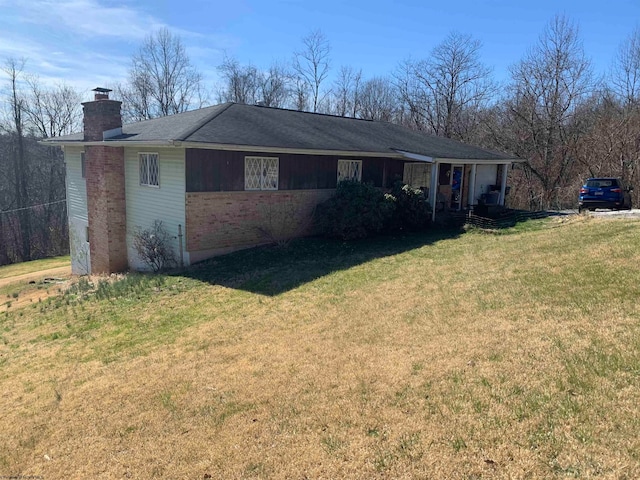 view of side of property with a lawn