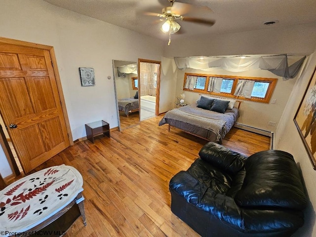 living room featuring ceiling fan, a baseboard heating unit, and light hardwood / wood-style floors