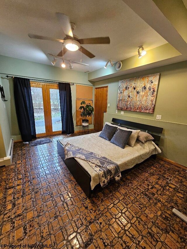 bedroom with dark tile flooring, a textured ceiling, ceiling fan, and track lighting