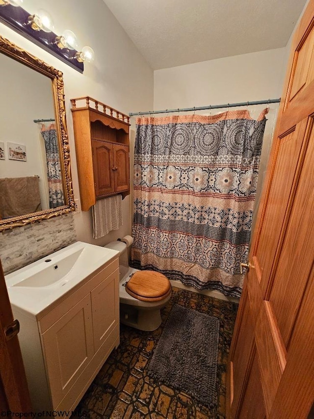 bathroom featuring tile flooring, toilet, tasteful backsplash, and vanity