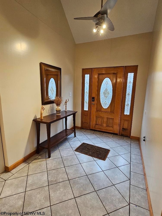 entrance foyer featuring ceiling fan, lofted ceiling, and light tile flooring