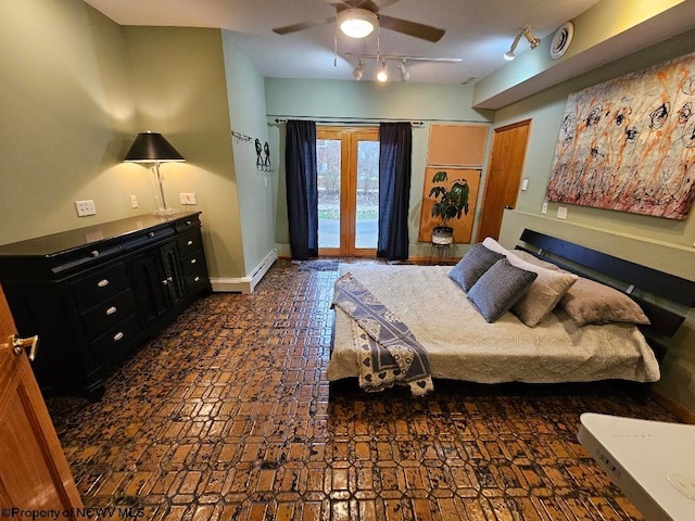 bedroom with ceiling fan, access to exterior, dark tile floors, a baseboard radiator, and rail lighting