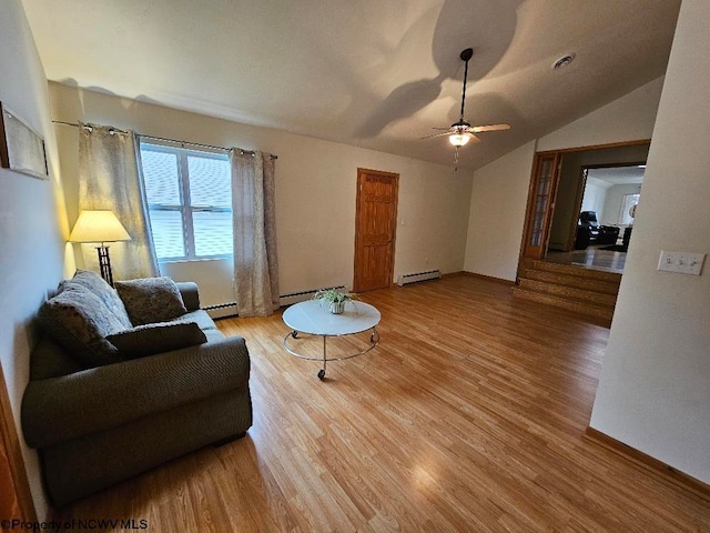 living room with light hardwood / wood-style flooring, ceiling fan, vaulted ceiling, and a baseboard heating unit