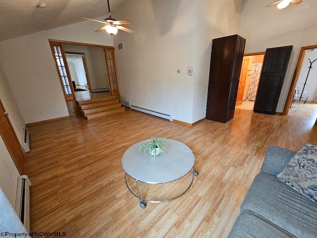 living room featuring lofted ceiling, ceiling fan, light wood-type flooring, and a baseboard radiator