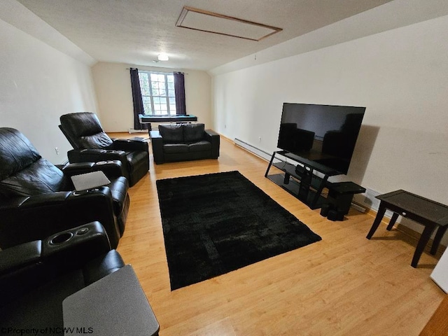 living room featuring light wood-type flooring and a textured ceiling