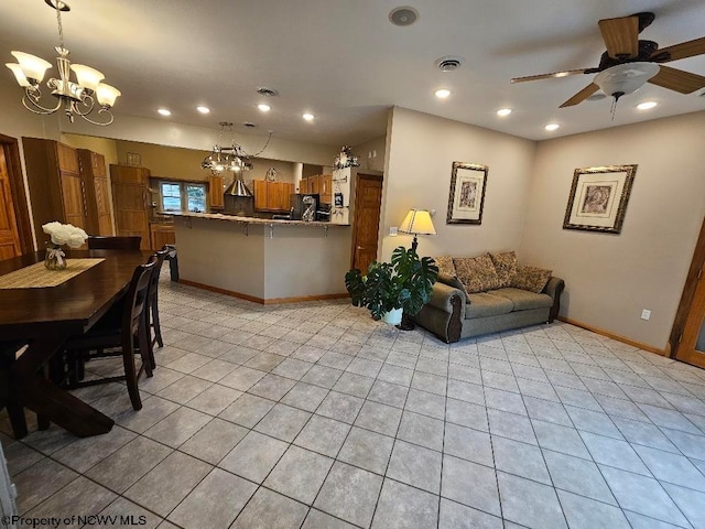 tiled living room featuring ceiling fan with notable chandelier