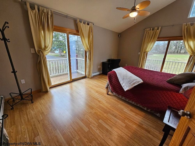 bedroom with multiple windows, lofted ceiling, access to exterior, and light hardwood / wood-style floors