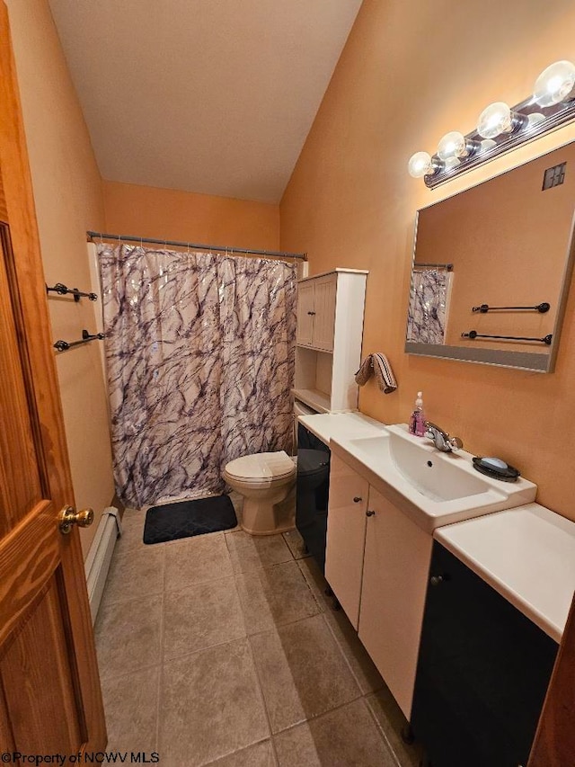 bathroom featuring tile floors, toilet, vaulted ceiling, and vanity with extensive cabinet space