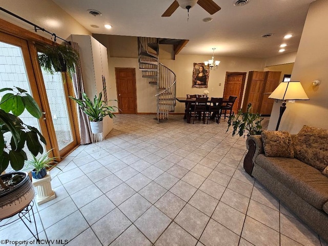 tiled living room featuring ceiling fan with notable chandelier